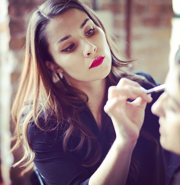 Nika Vaughan Bridal Artists makeup Artist Christina with red lips applying makeup to client