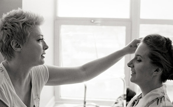 Nika Vaughan Bridal Artists makeup artist Lia Rivette applying makeup to bride
