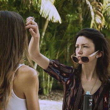 Nika Vaughan Bridal Artists hair/makeup artist Nora touching up the model's hair at Miami photo shoot 