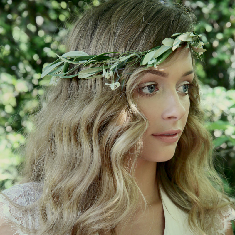 Blonde bride with green floral crown and beachy waves hair style