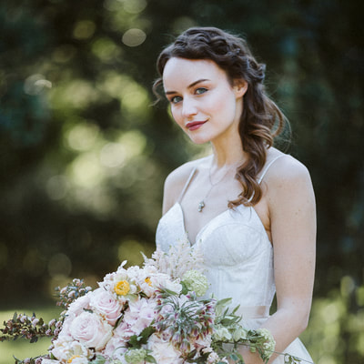 Bride with half updo hairstyle and bouquet